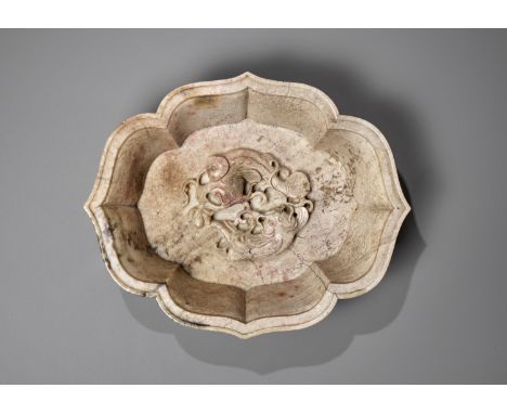 A CHICKEN BONE JADE 'DOUBLE FISH' MARRIAGE BOWL, 17TH-18TH CENTURYChina. The flared sides supported on four short feet and ri