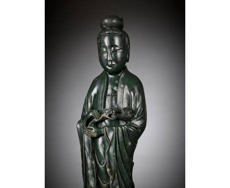 A LARGE AND MASSIVE SPINACH-GREEN KHOTAN JADE FIGURE OF GUANYIN, PROBABLY TAKEN FROM THE OLD SUMMER PALACE IN BEIJING IN 1861