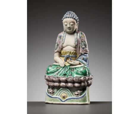 AN EXCEEDINGLY RARE FAMILLE VERTE BISCUIT FIGURE OF BUDDHA, KANGXI PERIODChina, 1661-1722. Seated in dhayanasana on a double 