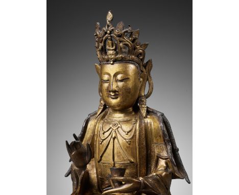 A LARGE GILT BRONZE 'WILLOW LEAF' GUANYIN, BHAISAJYARAJA AVALOKITESHVARA, MING DYNASTYChina, 16th century. Finely cast seated