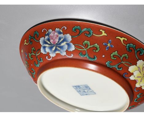 A FALANGCAI 'PEONIES AND WUFU' CORAL-GROUND DISH, QIANLONG MARK AND PERIODThe falangcai color palette of the present dish fir