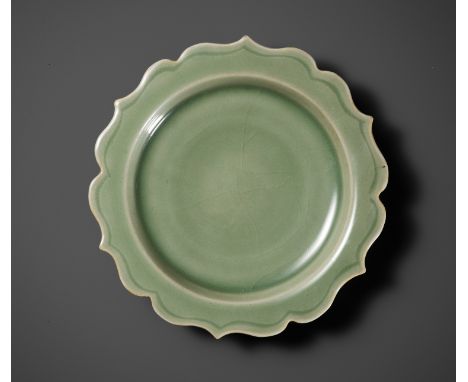 A LONGQUAN CELADON BARBED-RIM DISH, SONG TO YUAN DYNASTYChina, 960-1368. The concave shallow sides supported on a short taper