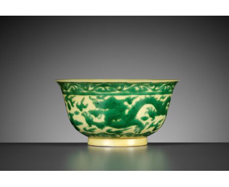 A YELLOW-GROUND GREEN-ENAMELED 'DRAGON' BOWL, KANGXI MARK AND PERIODChina, 1662-1722. The exterior is masterfully incised and