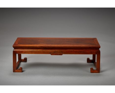 A RARE RECTANGULAR HUANGHUALI KANG TABLE, 18TH CENTURYChina. The well-figured single board floating panel top of typical mite