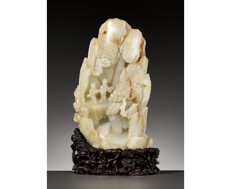 AN IMPORTANT AND RARE PALE CELADON AND RUSSET JADE MOUNTAIN, 18TH CENTURYChina. Finely carved to one side with a scholar and 