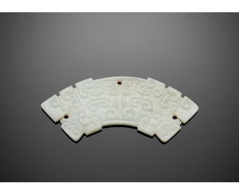 A WHITE JADE PENDANT, HUANG, EASTERN ZHOU DYNASTYChina, 8th-3rd century BC. Each side of the arc-shaped huang is intricately 