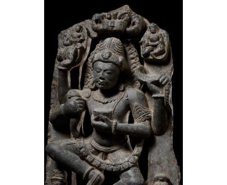 A LARGE AND EXCEPTIONAL GRAY SCHIST STATUE OF A DANCING SHIVA, EARLY MALLA DYNASTIESNepal, c. 12th-15th century. Finely carve