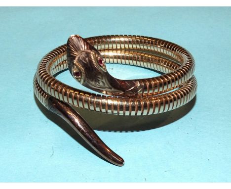 A 20th century 9ct yellow gold flexible snake bracelet, the head with engraved decoration and inset ruby eyes, 40cm long, int