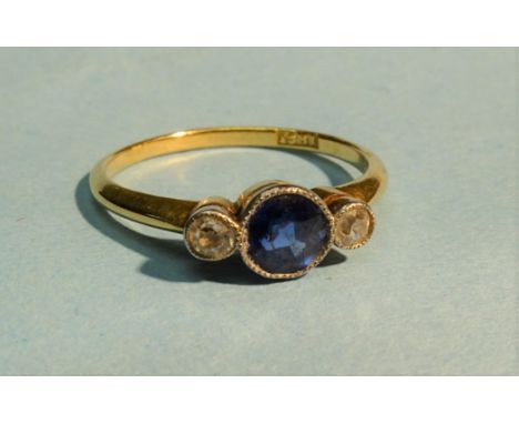 An Edwardian sapphire and diamond ring millegrain-set a round-cut sapphire between a brilliant-cut and 8/8-cut diamonds, in 1