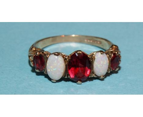 A 9ct gold ring alternately-set three garnets and two opals, size O, 2.9g. 