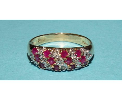 A 9ct gold ring set diagonal rows of round-cut rubies and diamond points, size O, 2.8g. 