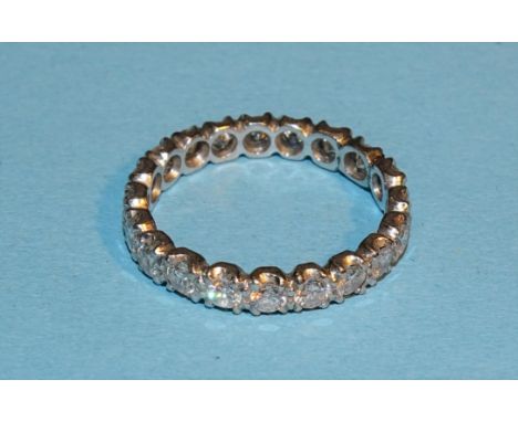 A diamond eternity ring claw-set twenty brilliant-cut diamonds, in unmarked white metal mount, (tests as platinum), (altered)