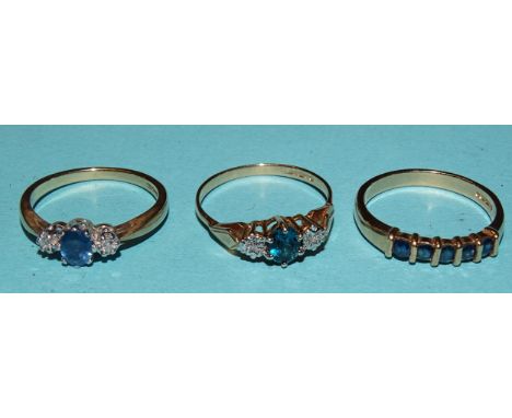 A 9ct gold ring set a round-cut sapphire and two brilliant-cut diamonds, size N, a similar blue topaz and diamond 9ct gold ri