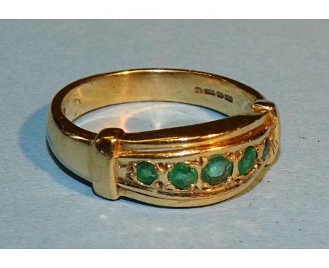 A modern 9ct gold gipsy ring set five graduated emeralds, size M½, 3.8g. 