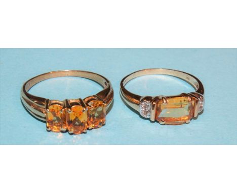 A 9ct gold ring set three oval citrines, size O and another set a fancy-cut citrine and four diamond points, size L½, 4.3g. 