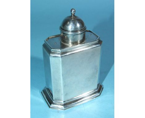 A George I silver tea caddy of rectangular shape with chamfered corners, sliding top with finialled dome and 'moulded' should