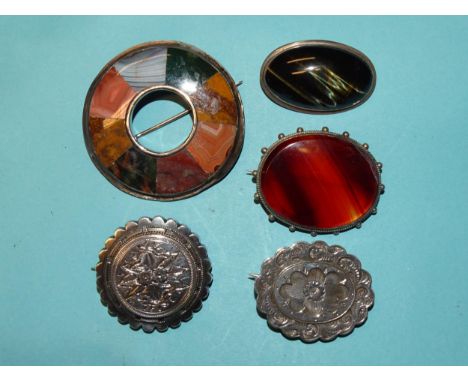 A multi-hardstone silver ring brooch (repaired), 50mm diameter, two other hardstone brooches and two Victorian silver locket-