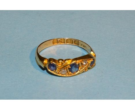 An early-20th century 18ct gold ring set three sapphires and two Swiss-cut diamonds, size L½, 3g. 