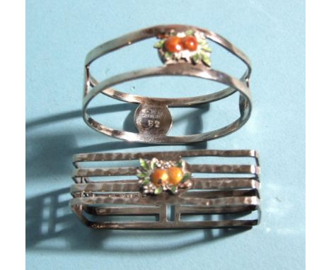 A sterling silver rectangular napkin ring with applied enamel orange fruit, 5 x 2.3cm and a similar circular napkin ring, 4cm