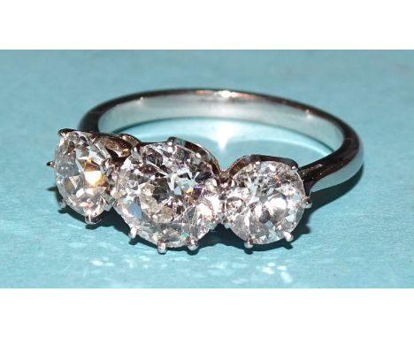 A three-stone diamond ring claw-set brilliant-cut diamonds of approximately 0.65cts, 1.2cts and 0.7cts, in platinum mount, ha