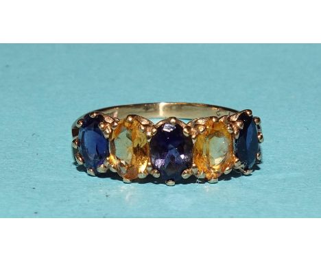 A five-stone 9ct gold ring set alternate iolites and citrines, size N½, 2.3g, (boxed). 