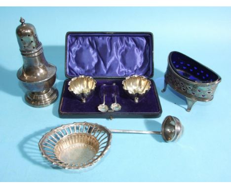 A George III pierced oval silver mustard pot, 5.5cm high, 9cm wide, with blue glass liner (damaged), a silver sugar castor wi