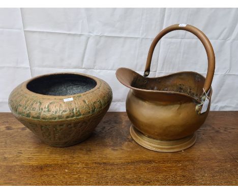 Indian brass jardinere with embossed decoration and a large brass coal helmet.
