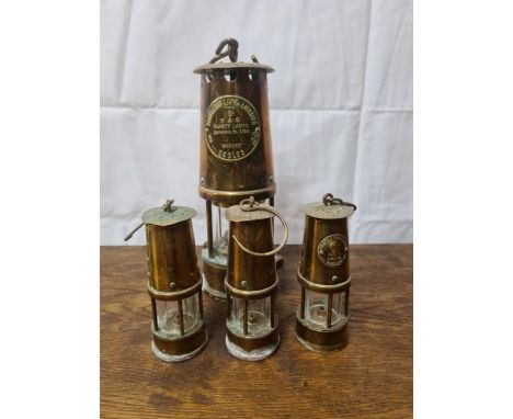 Eccles Type 6 miners lamp and 3 decorative miniature miners lamps.