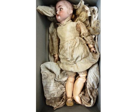 A SIMON & HALBIG FOR KAMMER & REINHARDT BISQUE SOCKET HEAD DOLL  with remains of a blonde wig, sleeping blue glass eyes, and 