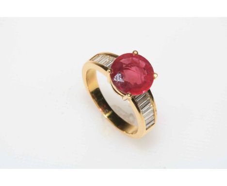 18 carat yellow gold ruby and diamond ring, the central circular 3.26 carat ruby flanked by seven baguette cut graduated diam