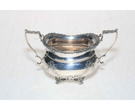 Edwardian silver sugar basin with floral swags and scroll paw feet, Sheffield 1906, 17cm across handles.