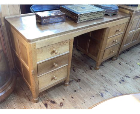 Robert Thompson of Kilburn 'Mouseman' adzed oak six drawer pedestal dressing table, 73cm by 137cm by 50cm.