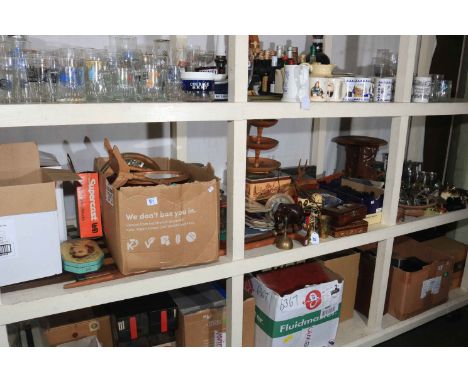 Full shelf of collectables including chess pieces and boards, metalware, carved wood pieces including Sherlock Holmes walking