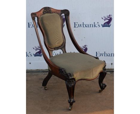 Victorian rosewood salon chair, with foliate and floral carved top rail and sweeping arms, padded splat and upholstered seat,