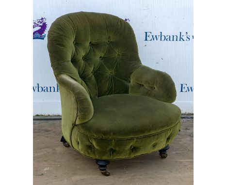 A 19th Century Green fabric upholstered button back salon chair raised on turned supports terminating in casters. 86 cm high 
