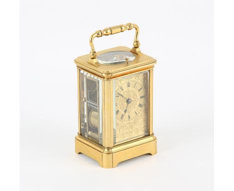 French brass carriage clock, the dial with Roman numeral chapter ring on a foliate and strapwork engraved back plate, with re