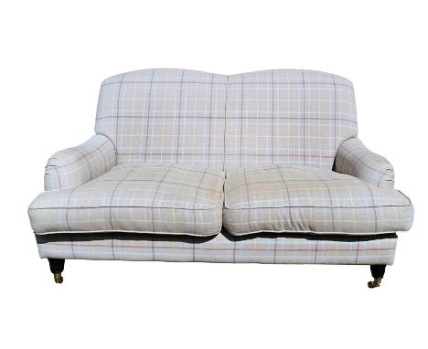 Tartan two-seater settee with shaped back and loose seat cushions, on turned stump supports, brass caps and castors, approx. 