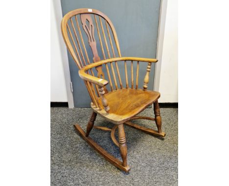 Elm and ash hoop and comb-back elbow rocking chair&nbsp;with pierced splats and crinoline stretcher, 100cm high x 60cm wide x