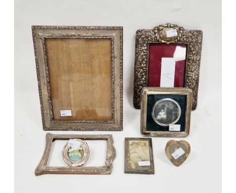 Seven silver photograph frames including a Victorian embossed pierced foliate scrolling frame, Birmingham 1900, 23cm x 17cm a