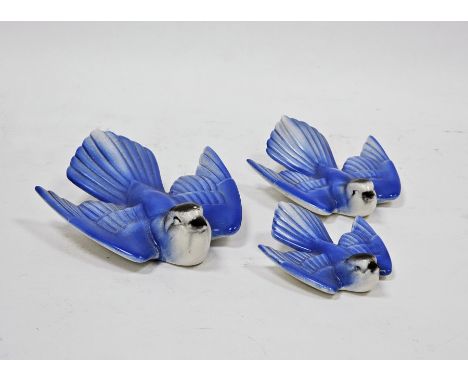 Graduated set of three Poole pottery models of blue birds, in sizes, enriched in blue and black, printed Poole England marks,