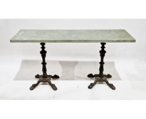 Concrete topped table, the rectangular top supported by a pair of 19th century cast iron pedestal legs, each having four paw 