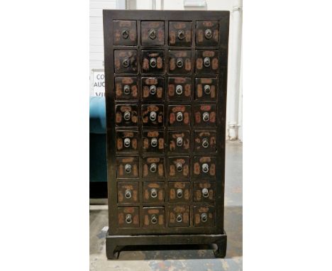 Chinese apothecary's stained wood nest of eight rows of four small drawers, each marked with characters and having metal drop