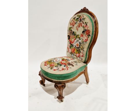 Victorian walnut nursing chair, the balloon back with foliate scroll carved top rail, on a shaped seat and front foliate scro