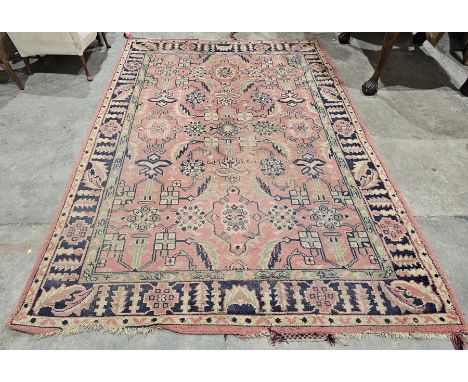 Large pink ground rug&nbsp;with central geometric motif, on geometric and floral field, multiple geometric borders (some wear