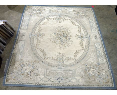 Large cream ground carpet with central oval floral medallion, floral spandrels and single geometric border, 301cm x 251cm&nbs