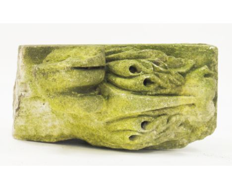 Antique sandstone architectural segment, possibly a corbel, the top carved with a scrolling leaf, the flat side with etched c