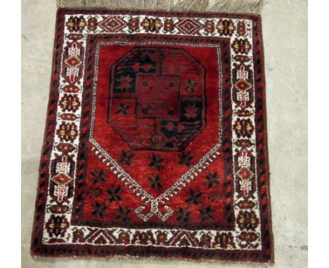 Pair of Eastern red ground prayer rugs with large elephant foot gul medallion, multiple geometric borders, 106cm x 90cm (2)  