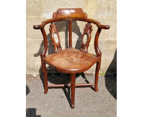 Chinese hardwood corner chair, the side back splats inset with marble oval plaques, solid seat, on four turned legs united by