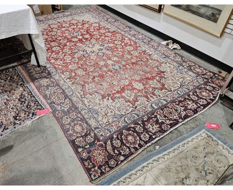 Eastern red ground carpet&nbsp;with central floral medallion on floral field, floral spandrels and multiple herati borders, 3