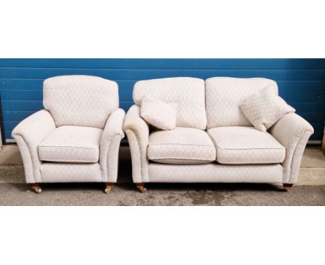 Parker Knoll two-seater sofa and matching armchair&nbsp;upholstered in a grey and beige pattern fabric, both on mahogany-effe